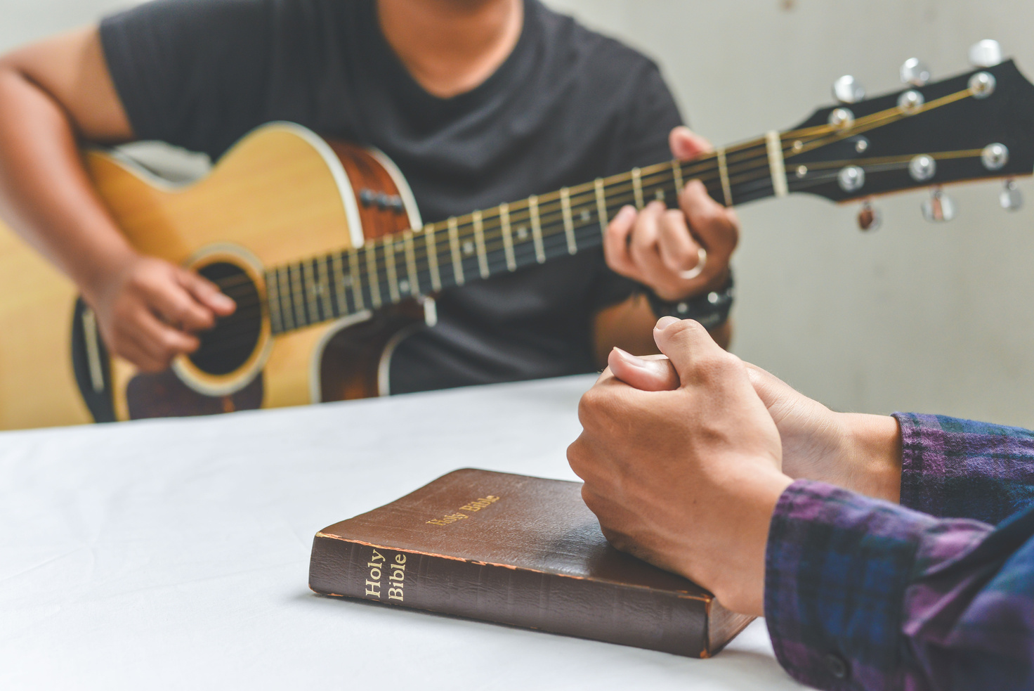 Christian family worship God in home, with a guitar and the Holy Bible. praise and worship concept